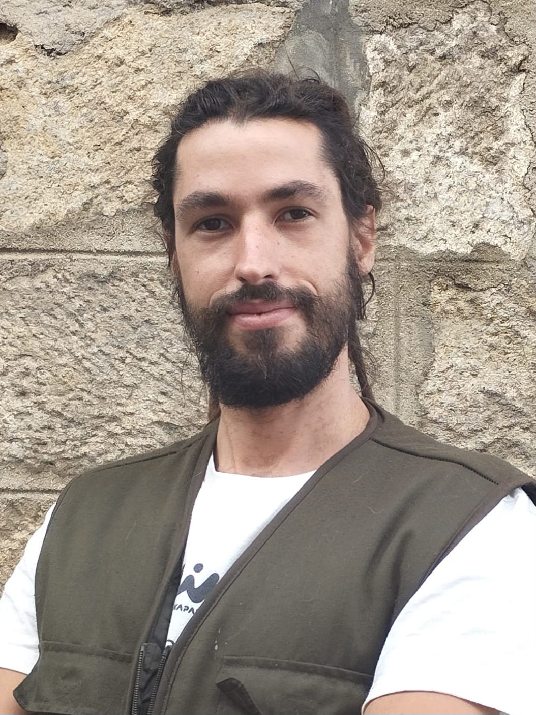 Portrait of a woman with brown hair on a flat gray background.